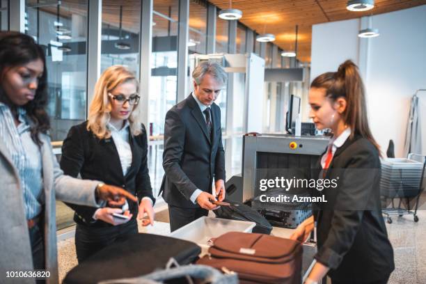 passengers standing by security scanner at airport - guard imagens e fotografias de stock