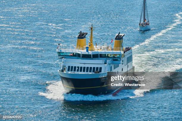 the ferry sailing between svendborg and the island aeroe (ærø) and sailboats arriving at the narrow waters of svendborgsund - ferry stock pictures, royalty-free photos & images