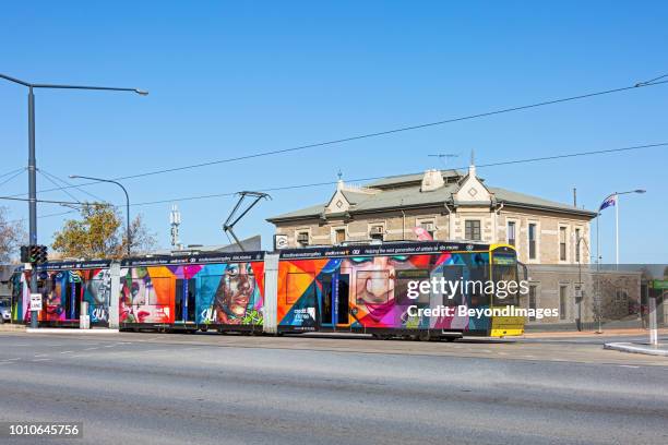 adelaide tram adorned with street art images advertising the sala festival, passing historic hotel - street art around the world stock pictures, royalty-free photos & images