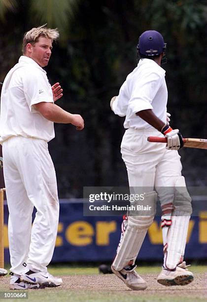 Shane Warne of Australia exchanges words with Pradeep Hewage of the Board XI after they collided mid pitch, during day three of the tour match...