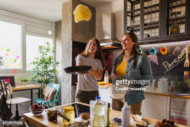 flipping pancakes - pancake stock pictures, royalty-free photos & images