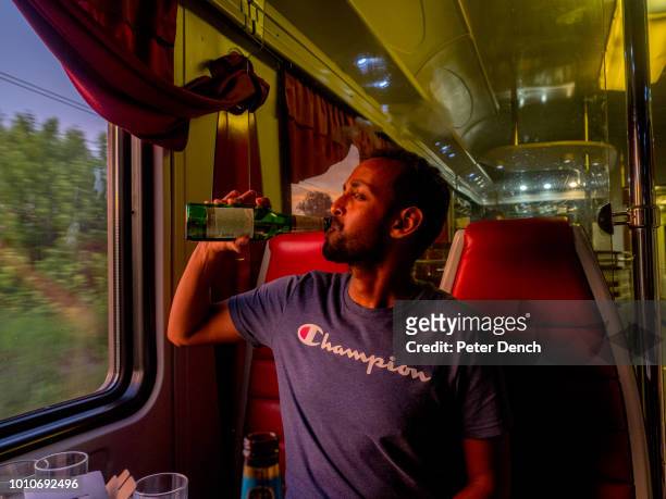 Somalian born, Norwegian national and Arsenal football fan, Abdi , drinks a beer in the restaurant on the Trans-Siberian Railway from...