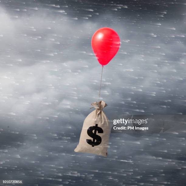balloon carrying money bag - climate change money stock pictures, royalty-free photos & images