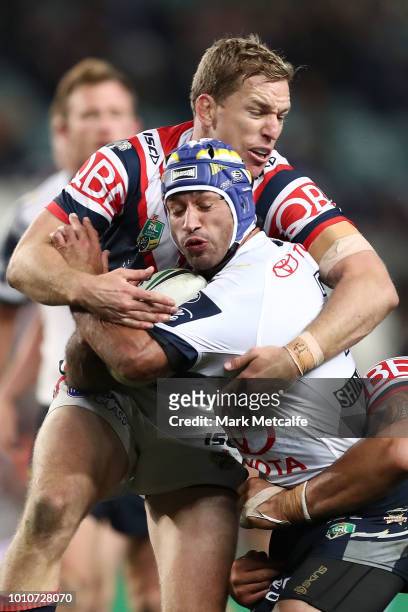 Johnathan Thurston of the Cowboys is tackled during the round 21 NRL match between the Sydney Roosters and the North Queensland Cowboys at Allianz...