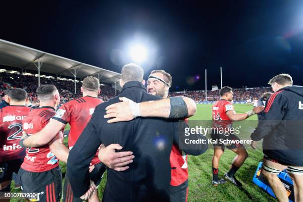 Tim Perry hugs Wyatt Crockett of the Crusaders after their win in the Super Rugby Final match between the Crusaders and the Lions at AMI Stadium on...