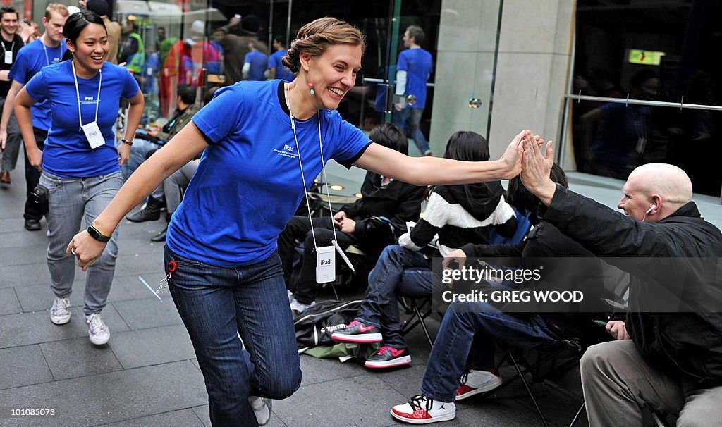 Apple store staff (blue) interact with m