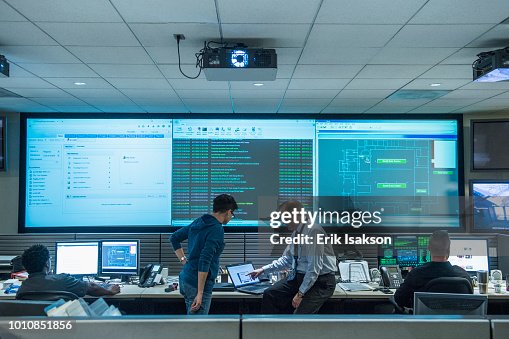 Colleagues working together in server control room Colleagues working together in server control room