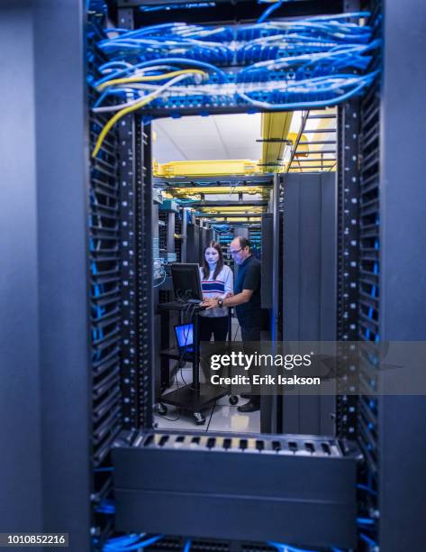 colleagues working together in server room - bandwidth management stock pictures, royalty-free photos & images