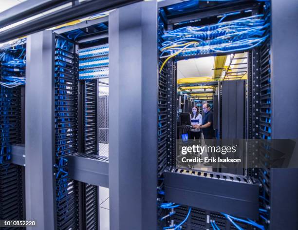 colleagues working together in server room - server room ストックフォトと画像