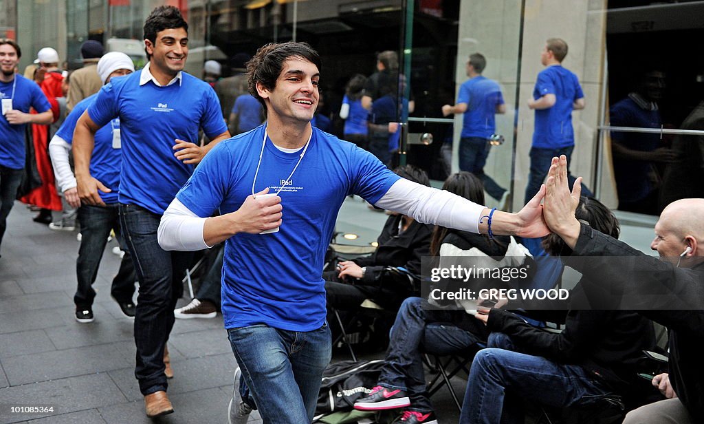 Apple store staff (blue) interact with m