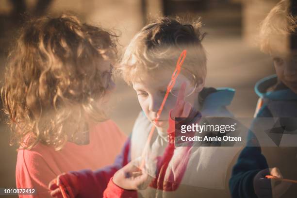 Double Exposure of Children Blowing Bubbles