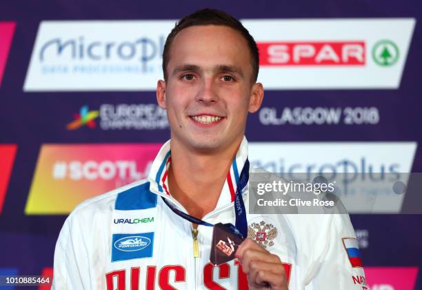 Bronze medallist Anton Chupkov of Russia poses during the medal ceremony for the Men's 100m Breaststroke Swimming Final on Day three of the European...