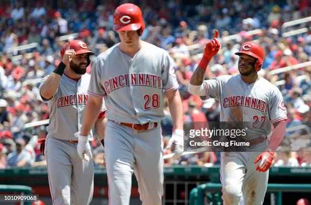 Phillip Ervin of the Cincinnati Reds celebrates after hitting a three-run home run with Anthony DeSclafani and Jose Peraza in the second inning...