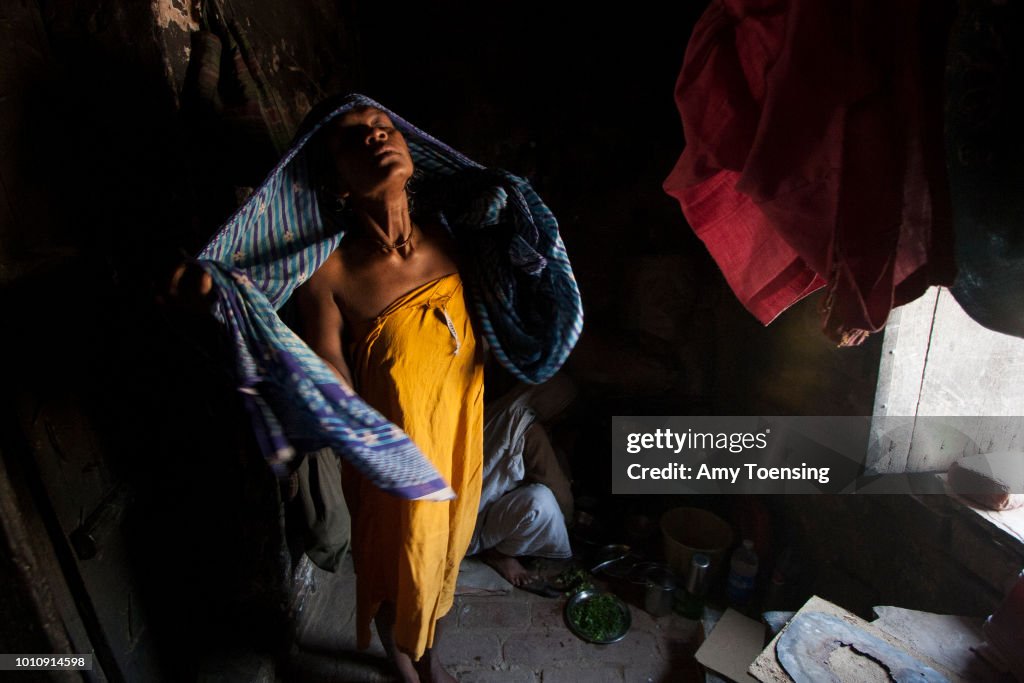 A widow gets dressed after bathing in an ashram in Vrindavan, India.