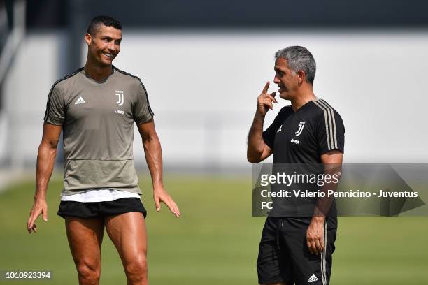 Cristiano Ronaldo of Juventus and Aldo Dolcetti talk during a training session at JTC on August 4, 2018 in Turin, Italy.
