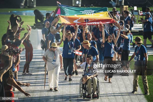 Participants march onto the field during the opening ceremony of the 2018 Gay Games edition at the Jean Bouin Stadium in Paris on August 4, 2018. -...