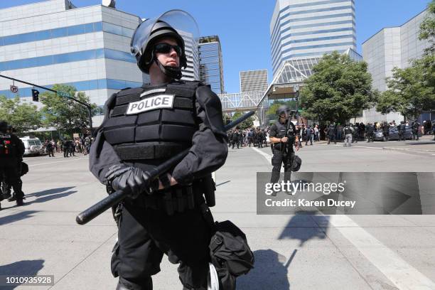 Riot police stand guard as right-wing demonstrators hold a rally supporting gun rights and free speech on August 4, 2018 in Portland, Oregon. The...