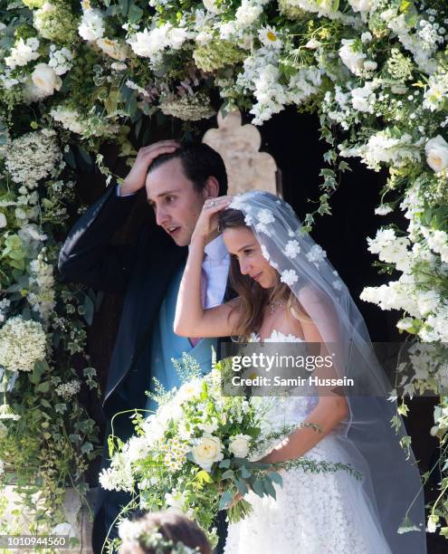 Bride Daisy Jenks and Charlie Van Straubenzee leave following their wedding on August 4, 2018 in Frensham, United Kingdom. Prince Harry attended the...