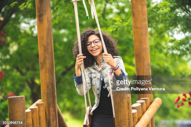 happy young girl having fun on the swing - preteen girl models stock pictures, royalty-free photos & images