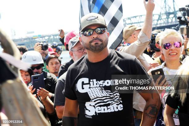 Rally organizer, Patriot Prayer founder and Republican Senate candidate Joey Gibson stands with alt-right activists in Portland, Oregon, August 4,...