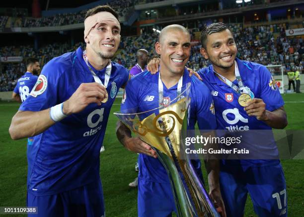 Maxi Pereira of FC Porto and teammates Hector Herrera of FC Porto and Jesus Corona of FC Porto celebrate with trophy after winning the Portuguese...