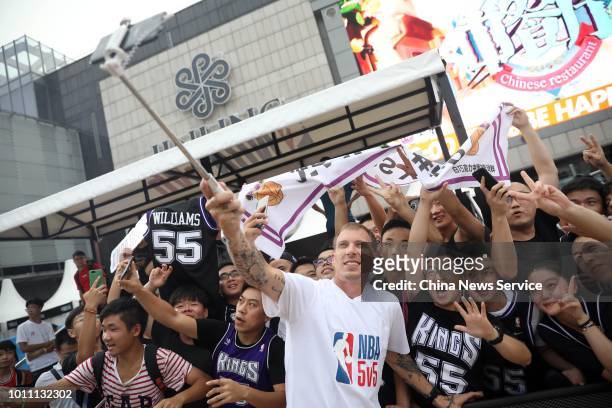 Former American NBA star Jason Williams takes a selfie with fans at the Nanjing 2018 NBA 5v5 competition on July 28, 2018 in Nanjing, Jiangsu...