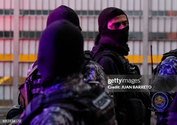 Security forces check a nearby building after an explosion was heard while Venezuelan President Nicolas Maduro was attending a ceremony to celebrate...