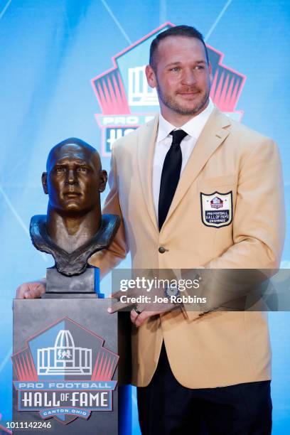 Brian Urlacher poses with is bust during the 2018 NFL Hall of Fame Enshrinement Ceremony at Tom Benson Hall of Fame Stadium on August 4, 2018 in...