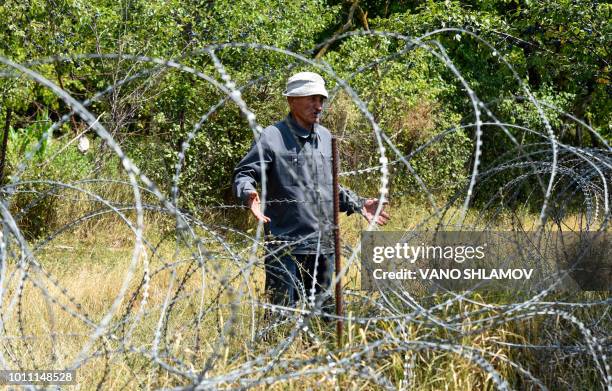Picture taken on July 25, 2018 shows Dato Vanishvili speaking with an AFP journalist while standing behind a wire barricade erected by Russian and...