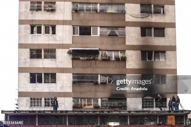 Security forces check a nearby building after an explosion was heard while Venezuelan President Nicolas Maduro was attending a ceremony to celebrate...