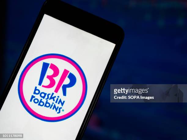 In this photo illustration, the Baskin-Robbins application seen displayed on a smartphone with a background of a stock market. Baskin-Robbins is an...