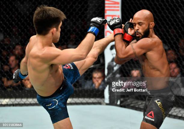 Henry Cejudo kicks Demetrious Johnson in their UFC flyweight championship fight during the UFC 227 event inside Staples Center on August 4, 2018 in...