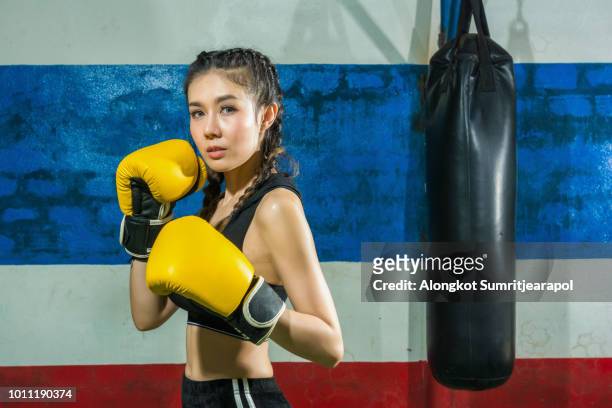 muay thai martial art, kickboxing. (attractive female boxer at training) - combat sport fotografías e imágenes de stock