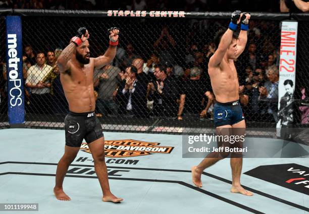 Demetrious Johnson and Henry Cejudo react after the conclusion of their UFC flyweight championship fight during the UFC 227 event inside Staples...