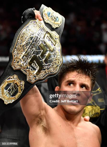 Henry Cejudo celebrates after his split-decision victory over Demetrious Johnson in their UFC flyweight championship fight during the UFC 227 event...