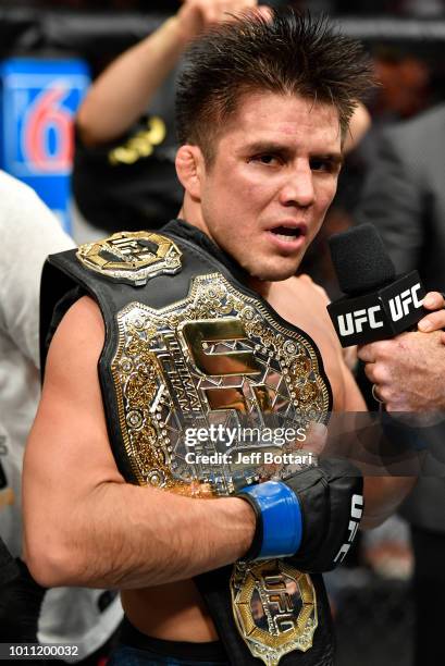 Henry Cejudo celebrates after his split-decision victory over Demetrious Johnson in their UFC flyweight championship fight during the UFC 227 event...