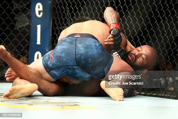 Demetrious Johnson fights Henry Cejudo on the ground in the fourth round of their UFC Flyweight Title Bout during UFC 227 at Staples Center on August...