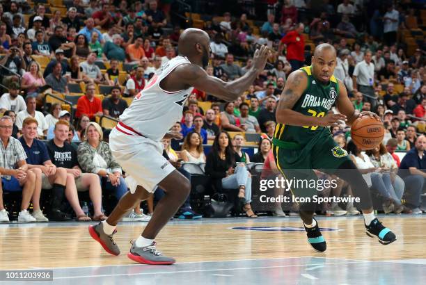 Andre Owens of Ball Hogs drives past Dion Glover of Trilogy during week 7 of the BIG3 basketball league on August 3 at TD Garden in Boston, MA....