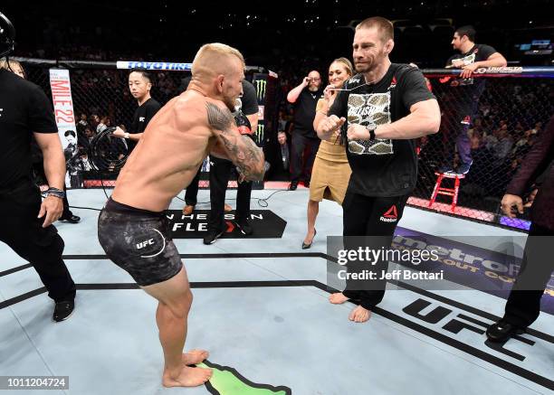 Dillashaw celebrates with coach Duane Ludwig after his knockout victory over Cody Garbrandt in their UFC bantamweight championship fight during the...