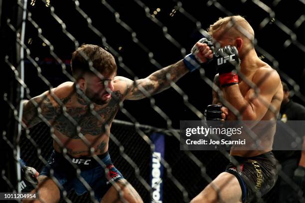 Cody Garbrandt punches TJ Dillashaw in the first round of the UFC Bantamweight Title Bout during UFC 227 at Staples Center on August 4, 2018 in Los...