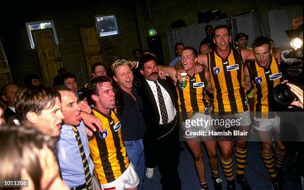 Hawthorn players celebrate in the team locker room after the Round 6 AFL Football match against Geelong played at Kardinia Park in Geelong,...