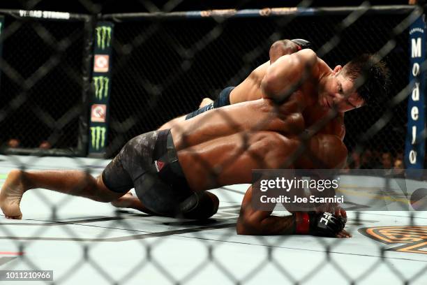 Henry Cejudo brings Demetrious Johnson to the ground in the third round of the UFC Flyweight Title Bout during UFC 227 at Staples Center on August 4,...