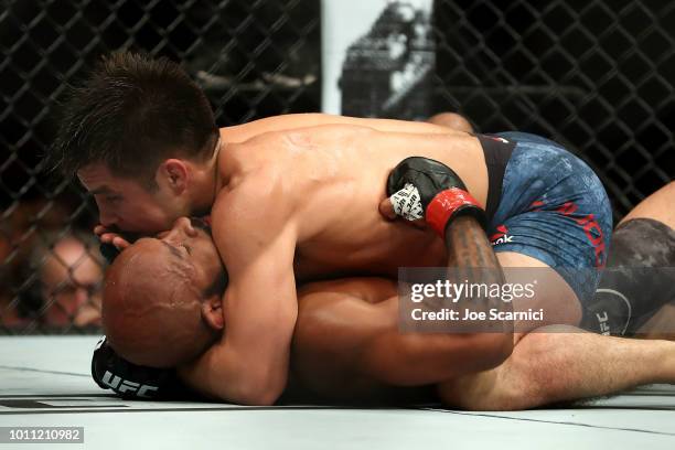 Henry Cejudo fights Demetrious Johnson on the ground in the second round of the UFC Flyweight Title Bout during UFC 227 at Staples Center on August...