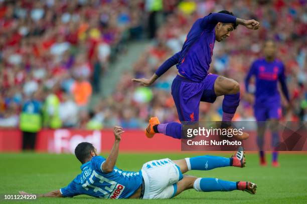 Roberto Firmino of Liverpool jumps over Raul Albiol of Napoli during the International Club Friendly match between Liverpool FC and SSC Napoli at...