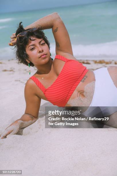 Young confident woman laying on the beach