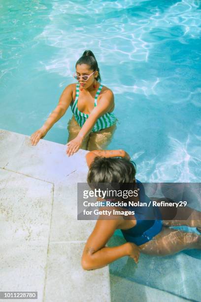Two young confident women relaxing in the pool