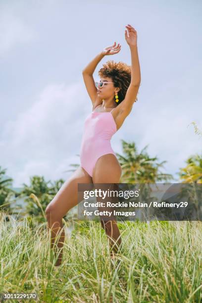 Young confident woman standing on the beach