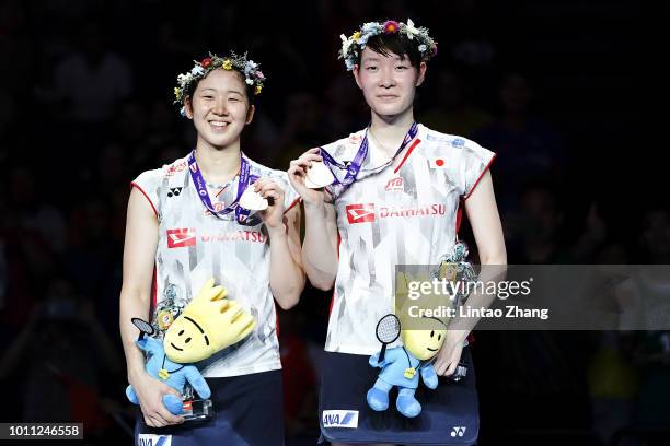 Mayu Matsumoto and Wakana Nagahara of Japan pose with their medals during the Women's Doubles awarding ceremony after defeating Yuki Fukushima and...