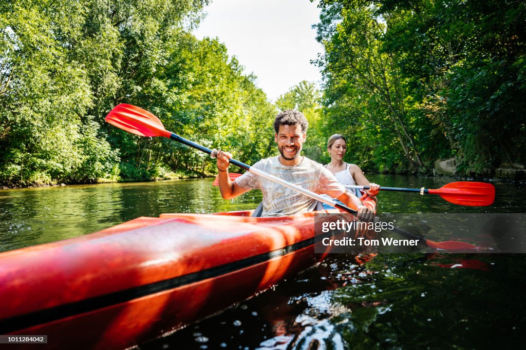 Couple Paddling Together In Kayak