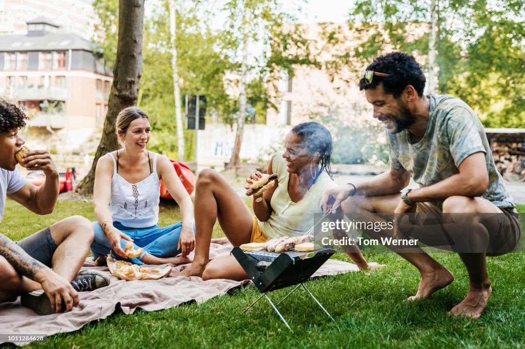 Group Of Friends Having BBQ By Canal